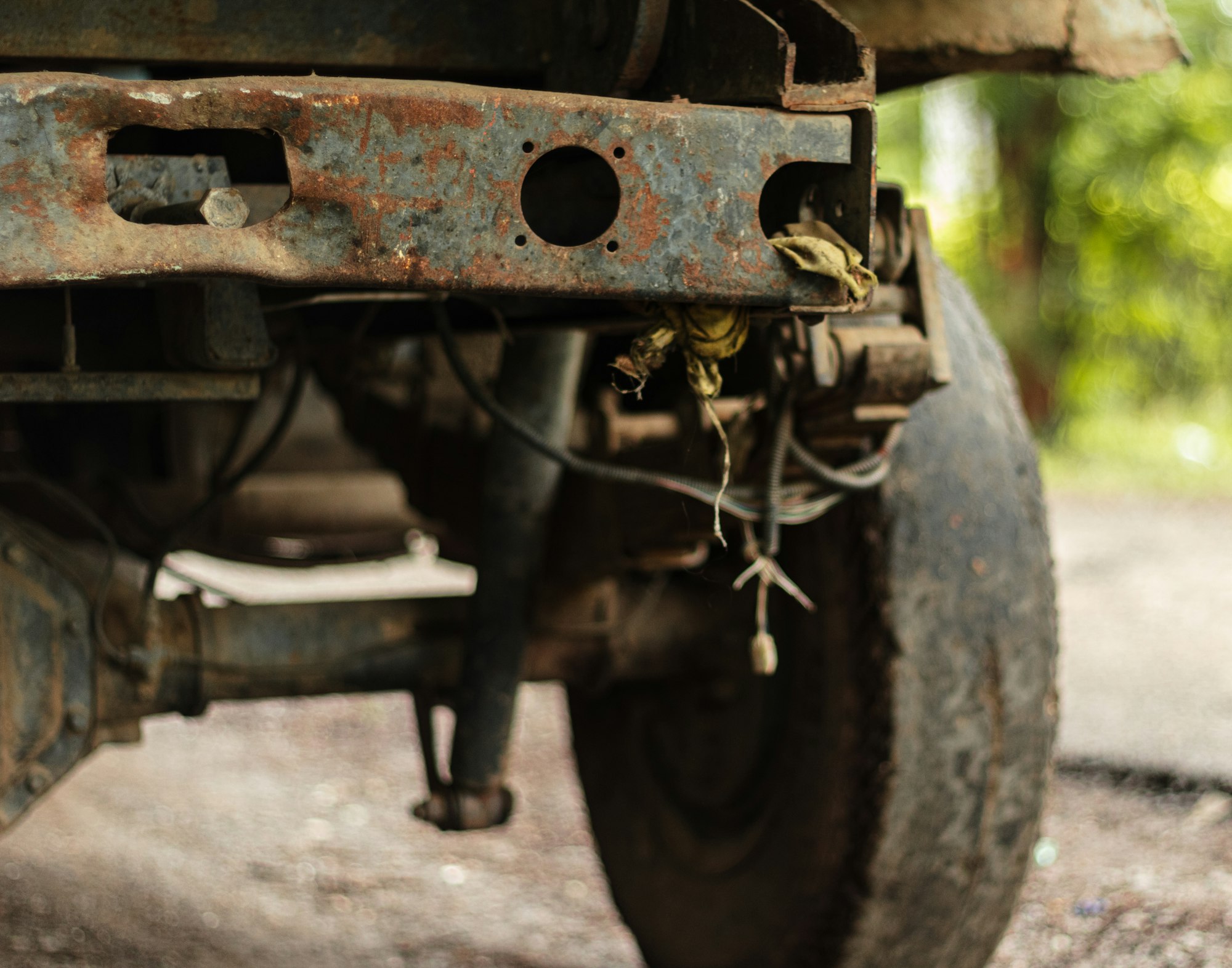 Close-up of heavy rust corrosion on a vehicle's rear axle and suspension components