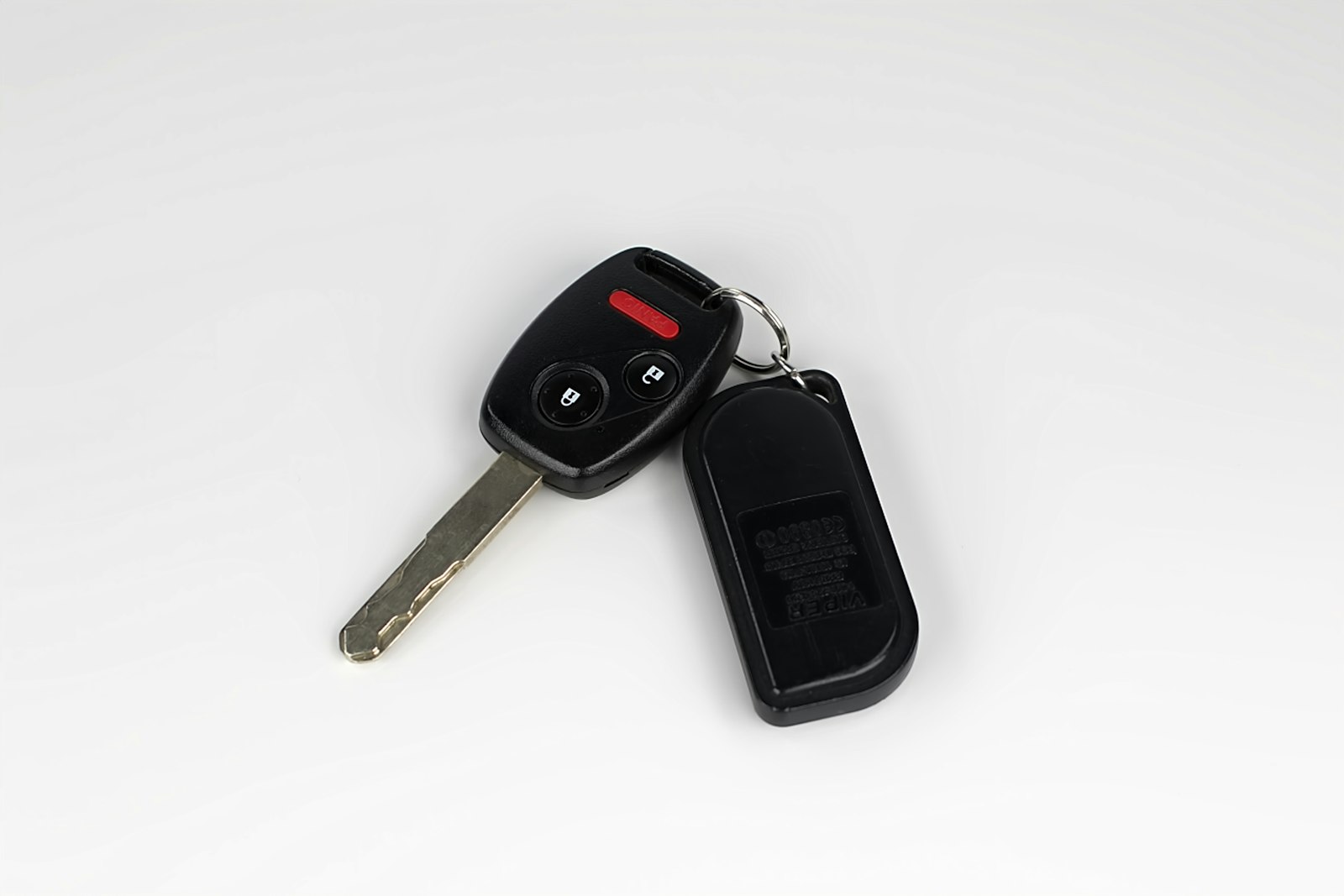 Close-up of a single car key with its remote fob attached