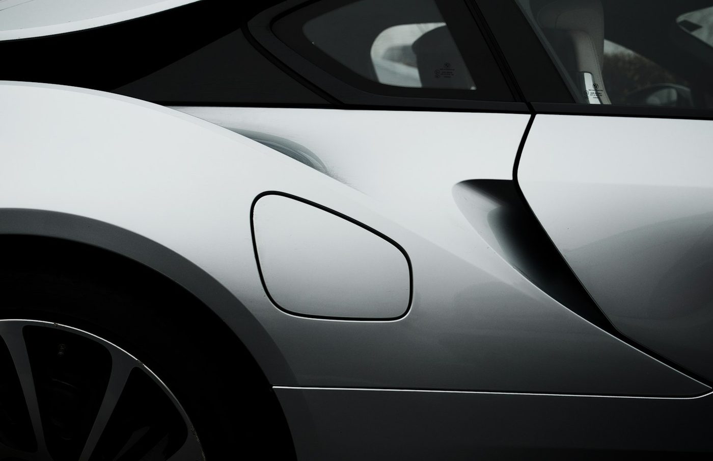 Close-up of a clean, undamaged silver car fender and door panel